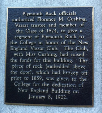 Plague reads: Plymouth Rock officials authorized Florence M. Cushing, Vassar trustee and member of the Class of 1874, to give a segment of Plymouth Rock to the College in honor of the New England Vassar Club. The Club, with Miss Cushing, had raised the funds for this building. The piece of rock (embedded above the door), which had broken off prior to 1859, was given to the College for the dedication of New England Building on January 8, 1902.